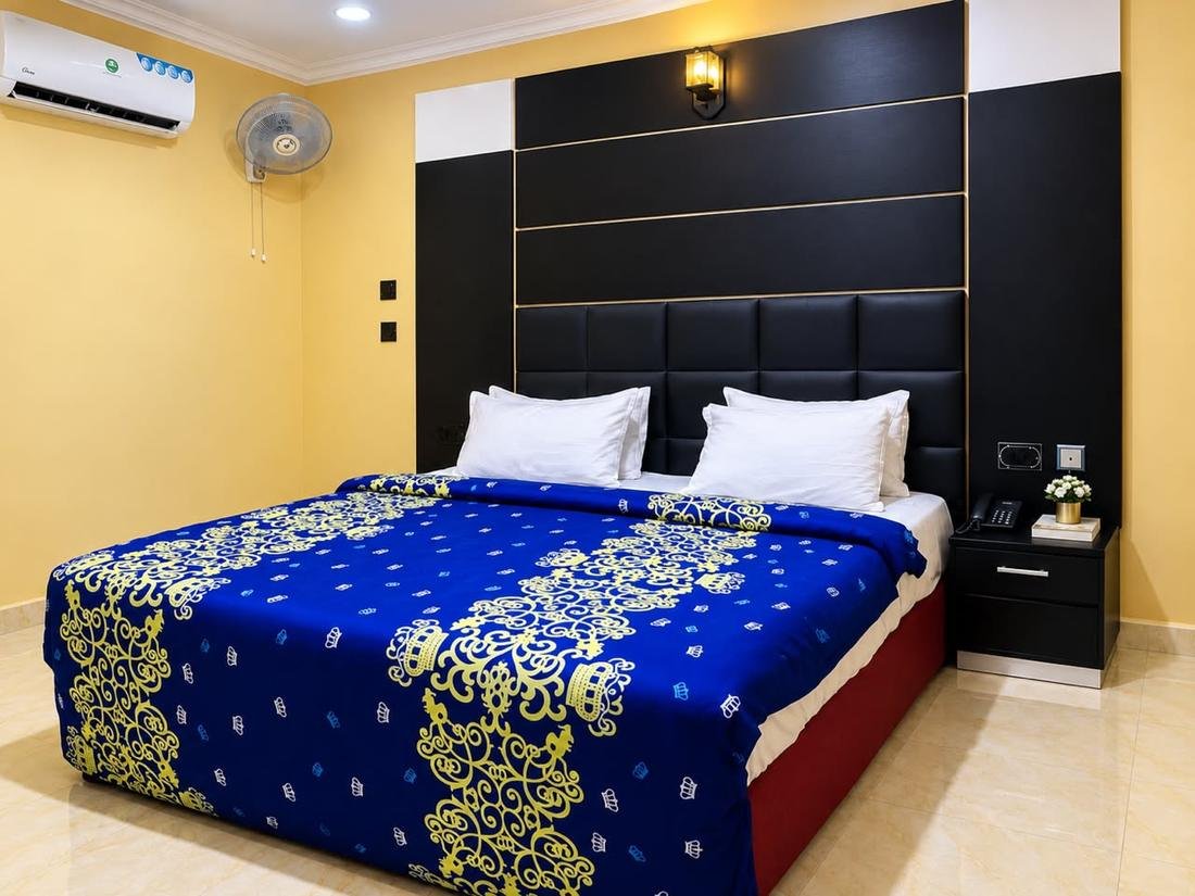 Royal Room bed with blue crown-pattern bedding